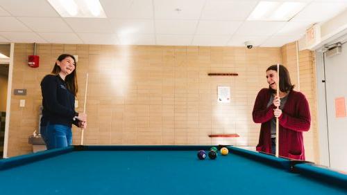 Students playing billiards at the dorm